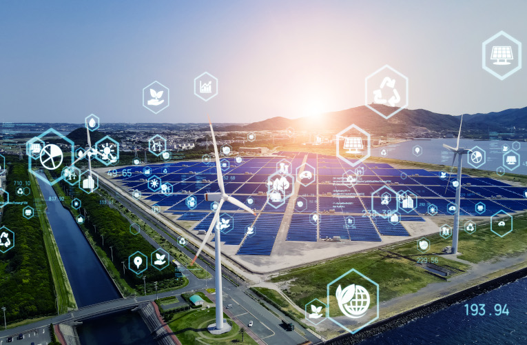 Aerial view of solar panels and wind turbines with digital grid icons, illustrating DERMS forecasting and distributed energy management.